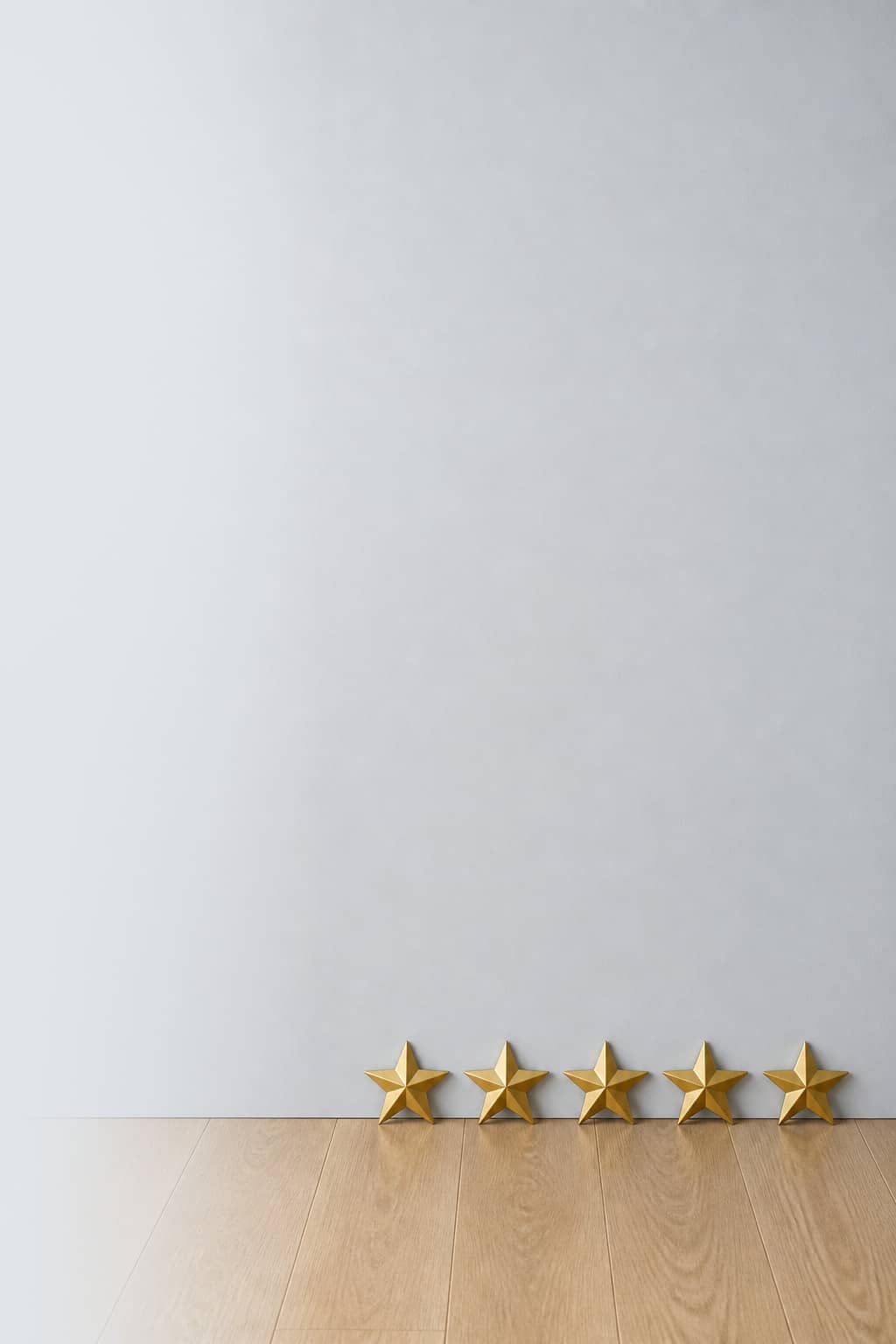 Five gold stars against a dusty mist painted wall