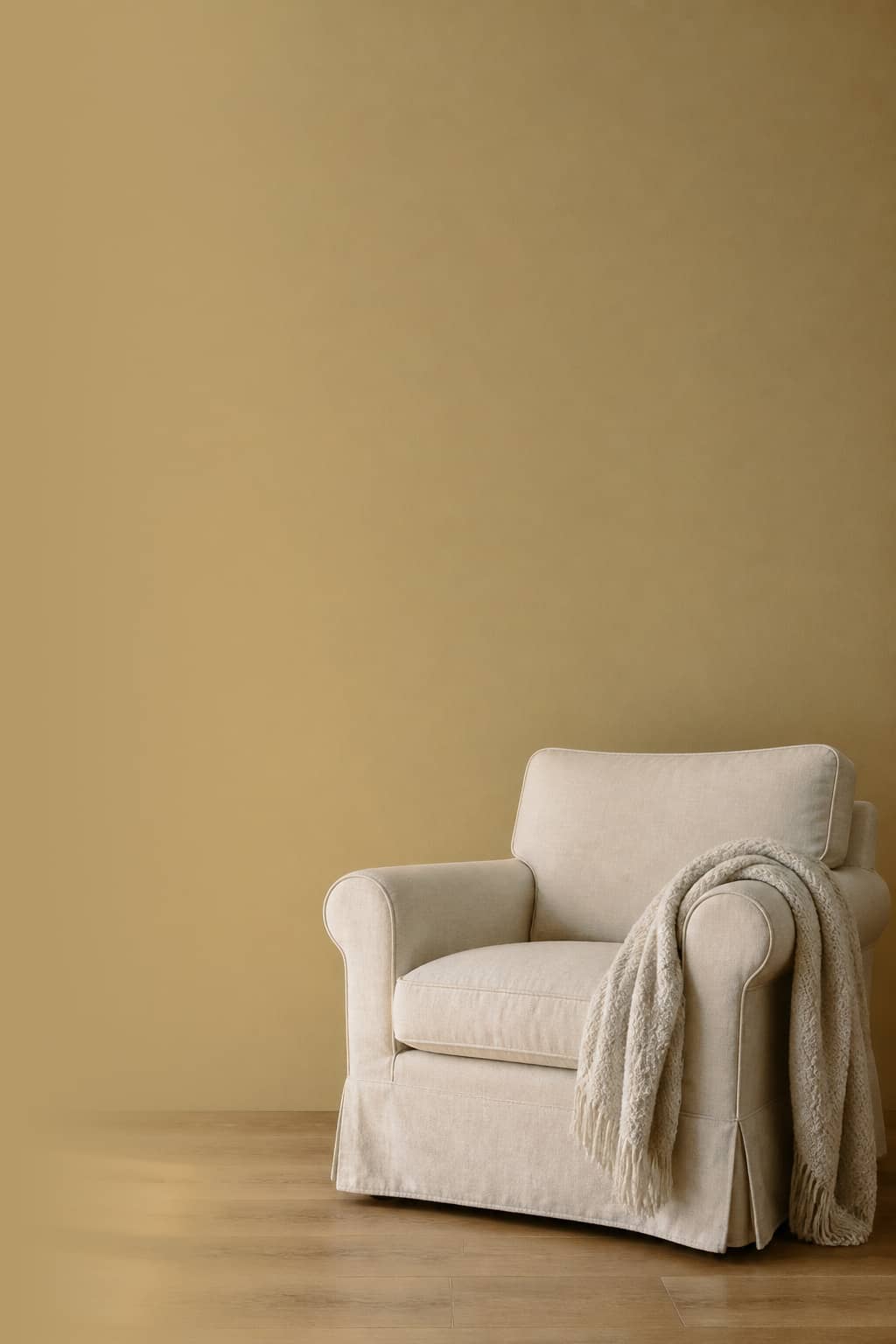 Armchair against a muted gold painted wall